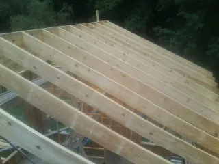 New roof rafters set over an addition before sheathing in Beachwood