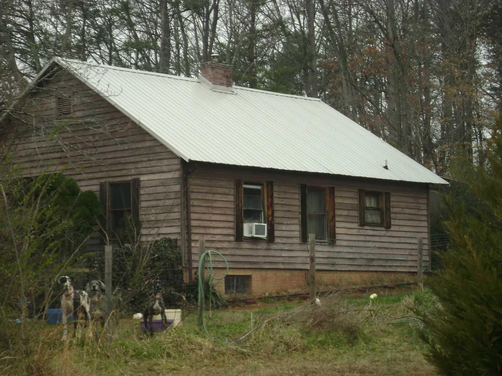 White metal roof on an old wood sided farmhouse, from a Metal Roof Installation job in Beachwood